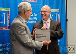 Dean Bill Kiernan is presented with a gift from ICI director Tom Sannicandro